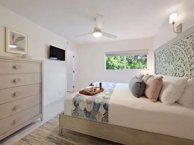 Primary bedroom alternate angle with dresser and TV