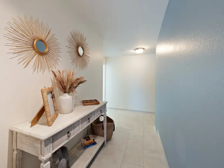 Entry foyer with sunburst mirrors and console table