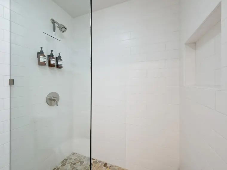 Shower detail with subway tile and dispensers