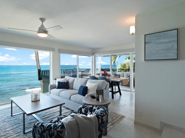 Living room with sofa and floor-to-ceiling ocean view