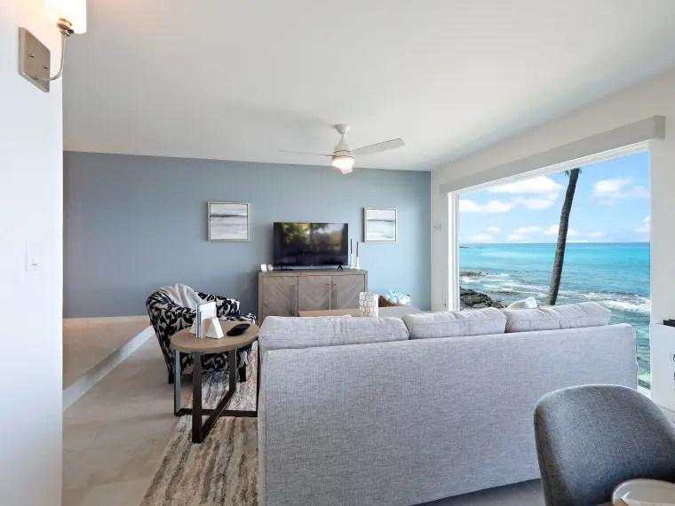 Living room wide angle with blue wall and ocean horizon